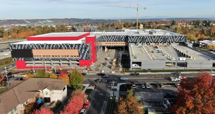 Aerial view of the Emerald Queen Casino complex under construction, showing completed structure and parking deck.