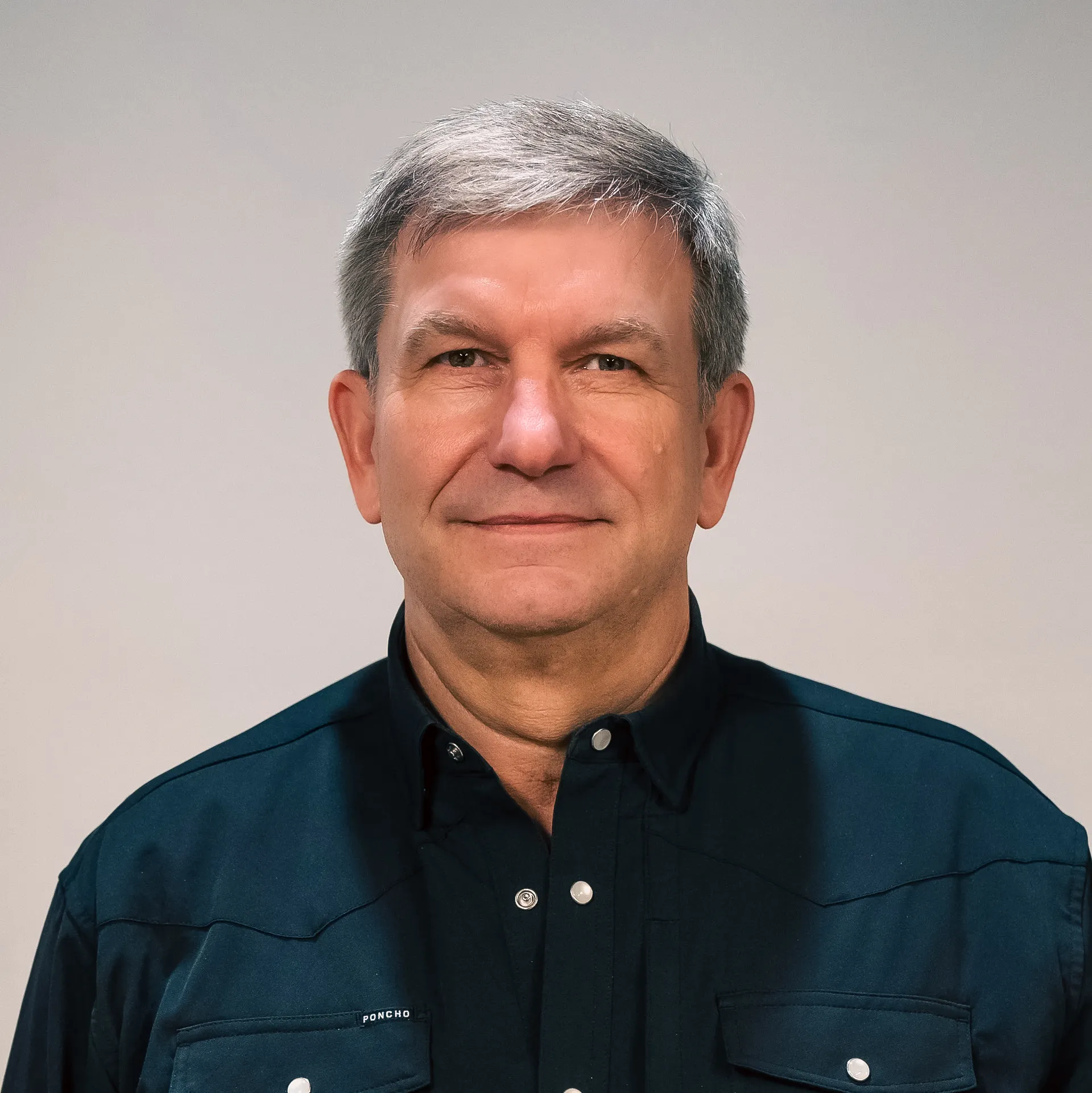 Michael Tungsvik in a dark collared shirt, representing the operations management team.