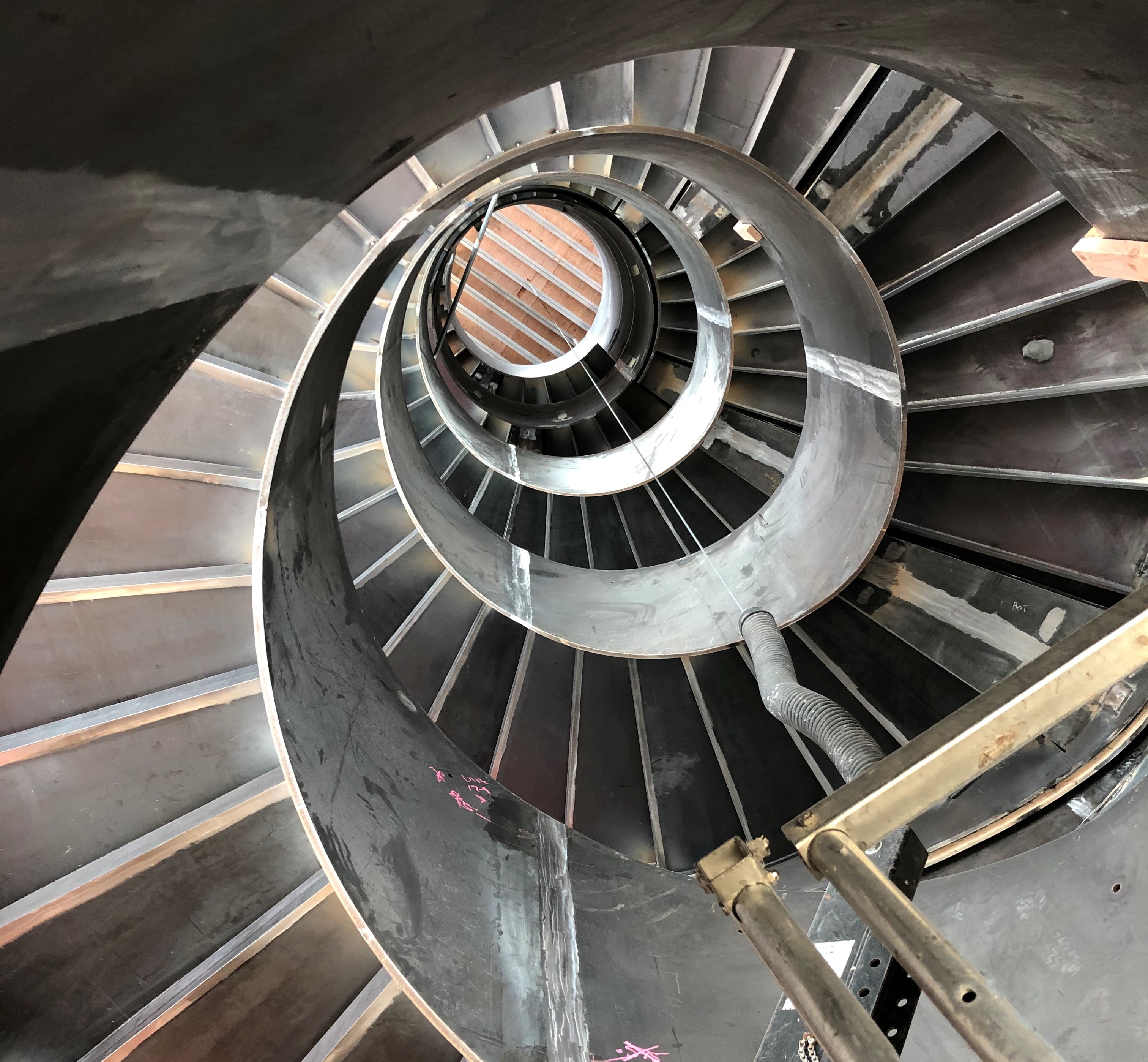 Elevator shaft retrofit tendon relocation
