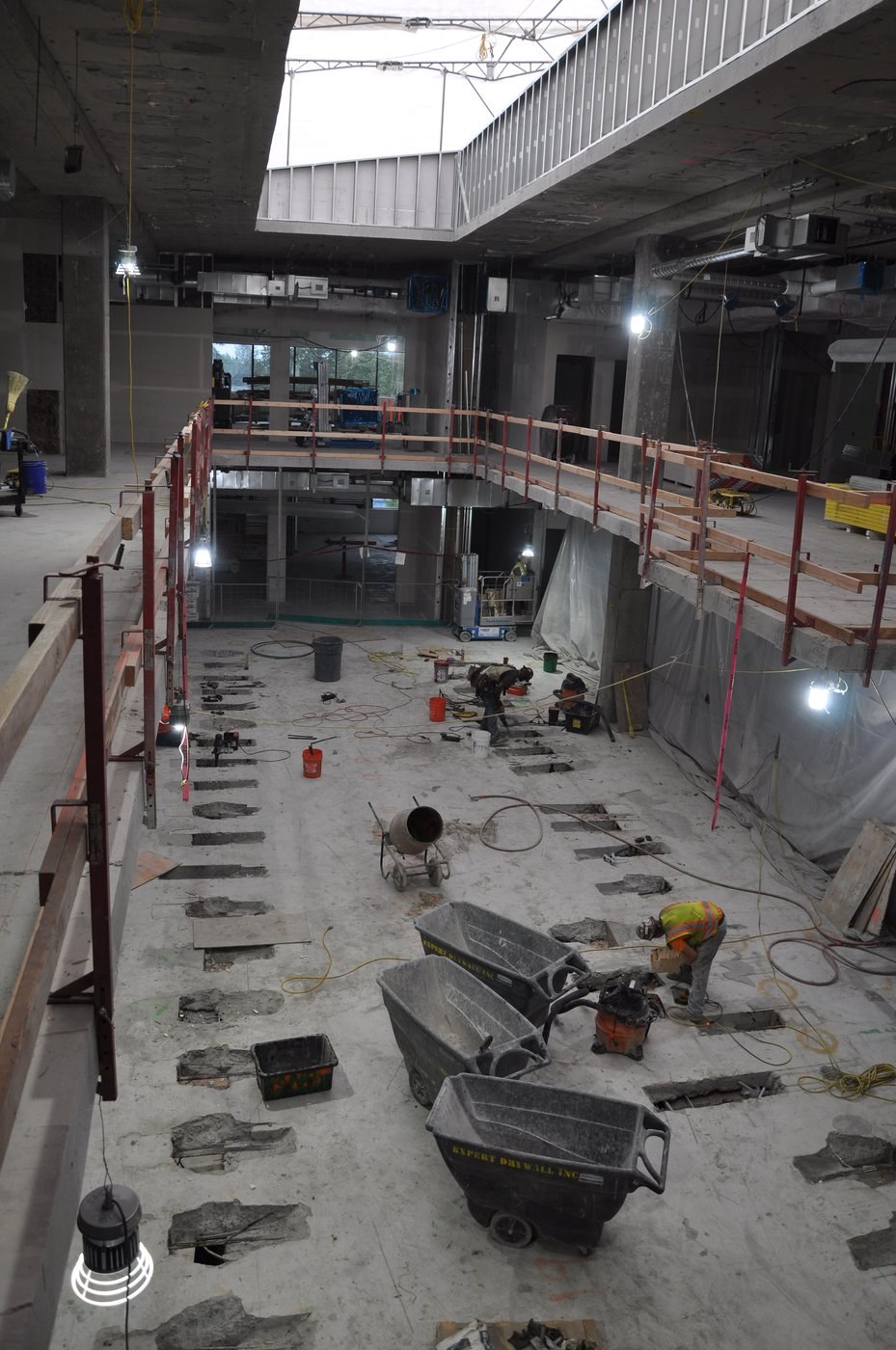 Inside Building 122 mid-job. Multi-level openings, skylight cuts and other trades working at the same time.